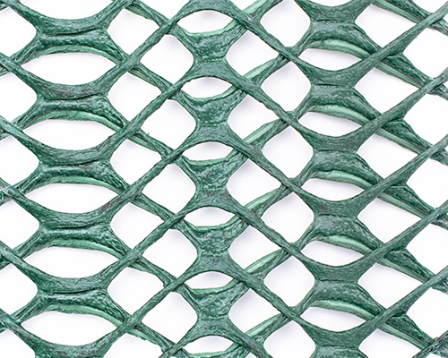 Extreme close-up of Tenax Keep-It-Green mesh showing the distinctive elliptical open-cell aperture structure
