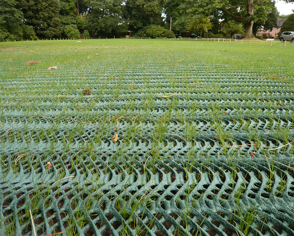 Extreme close-up of Tenax GP Flex mesh showing the distinctive oscillated wave structure of the HDPE reinforcement
