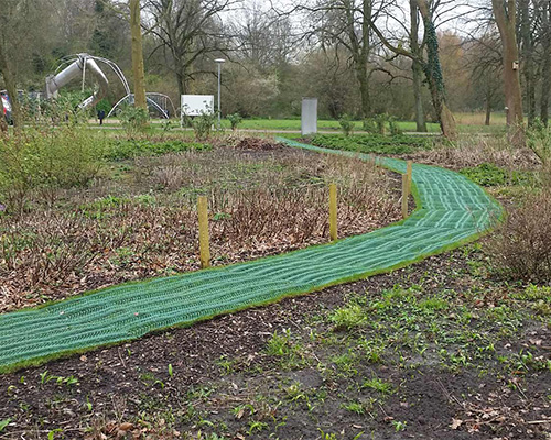 Tenax GP Flex mesh installed along a curved garden path in a natural landscape setting, showing flexible mesh application to irregular shapes