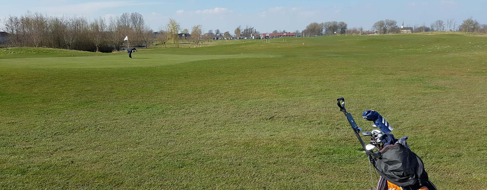 Golfer with trolley on a Tenax GP Flex reinforced grass fairway or path at a golf course or park, showing turf reinforcement in a golf setting