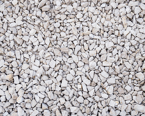 Close-up of loose white gravel surface used as a comparison alternative to Tenax grass reinforcement mesh for ground protection