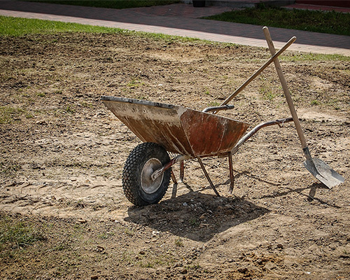 wheelbarrow sitting in dirt