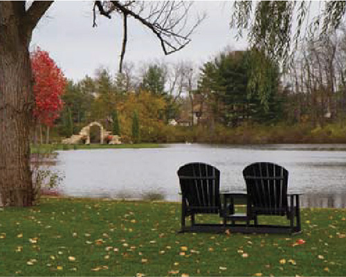 Lakeside seating area with Adirondack chairs on green lawn at Gervasi Vineyard, showing lawn protection in an upscale event setting