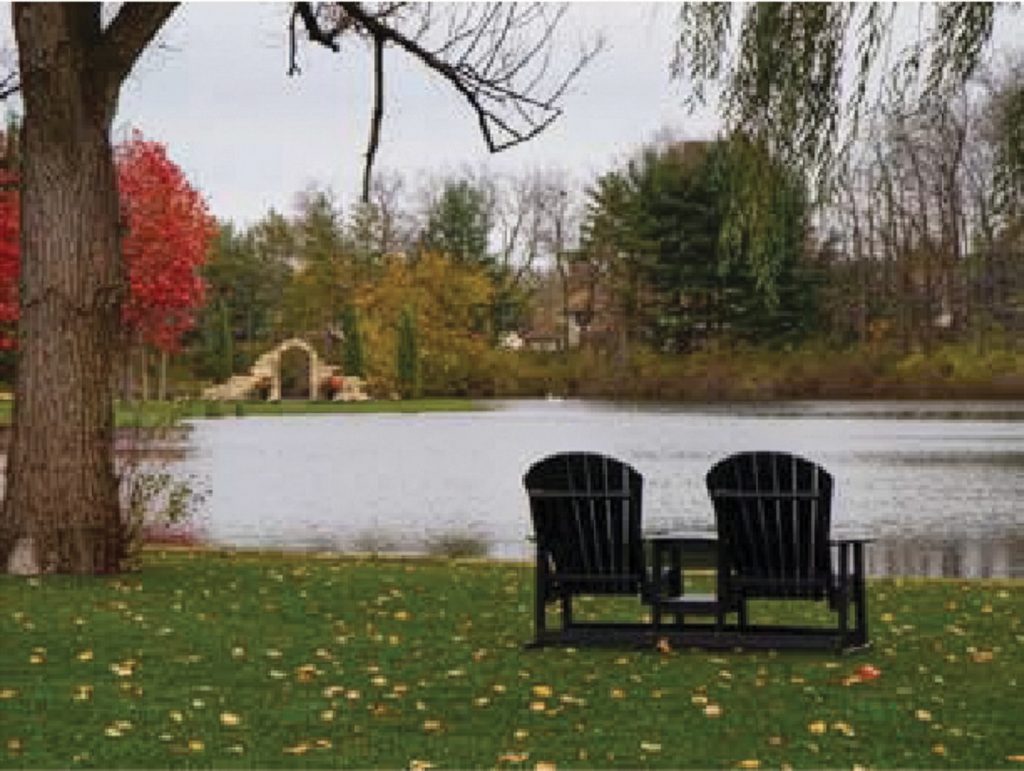 Lakeside seating area with Adirondack chairs on green lawn at Gervasi Vineyard, showing lawn protection in an upscale event setting